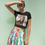girl-blocking-the-sun-wearing-a-t-shirt-mockup-and-a-colorful-skirt-a19538
