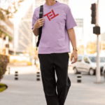 mockup-of-a-tall-man-with-a-round-neck-tee-walking-on-the-sidewalk-m25262