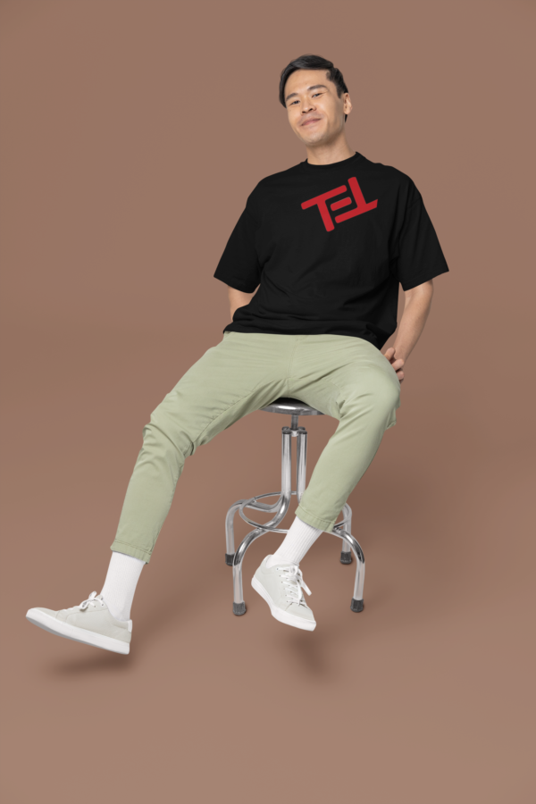 oversized-round-neck-tee-mockup-of-a-smiling-man-sitting-on-a-stool-in-a-studio-m38925