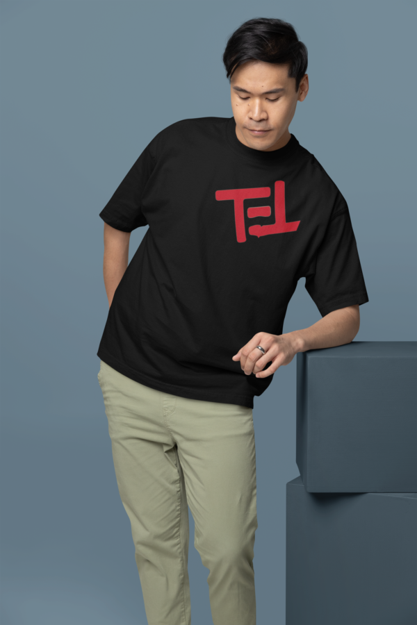 oversized-t-shirt-mockup-featuring-a-man-leaning-on-a-colorful-cube-m38921