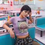 sleepy-girl-wearing-a-crop-top-tee-mockup-sitting-down-a19414