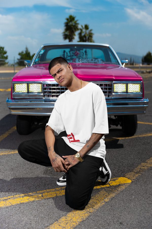 stanley-stella-tee-mockup-of-a-tattooed-man-posing-in-front-of-a-muscle-car-m36828