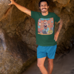 t-shirt-mockup-of-a-tattooed-man-leaning-against-a-big-rock-by-the-beach-26804